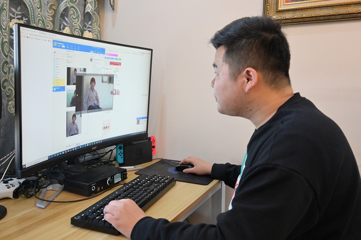 A man uses AI technology in March 2021 to restore old photos in Chizhou, East China’s Anhui Province. Photo: VCG