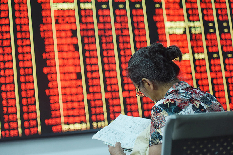 An individual investor studies stock market performance at a brokerage in Hangzhou, Zhejiang province, on Sept. 24, 2024.